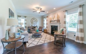 A living room with a fireplace and wooden floors