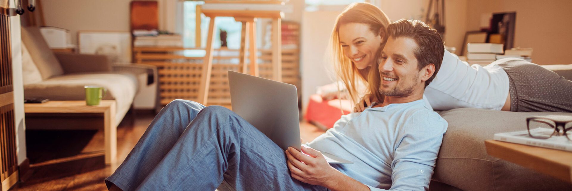 A woman sitting on the ground with her laptop.