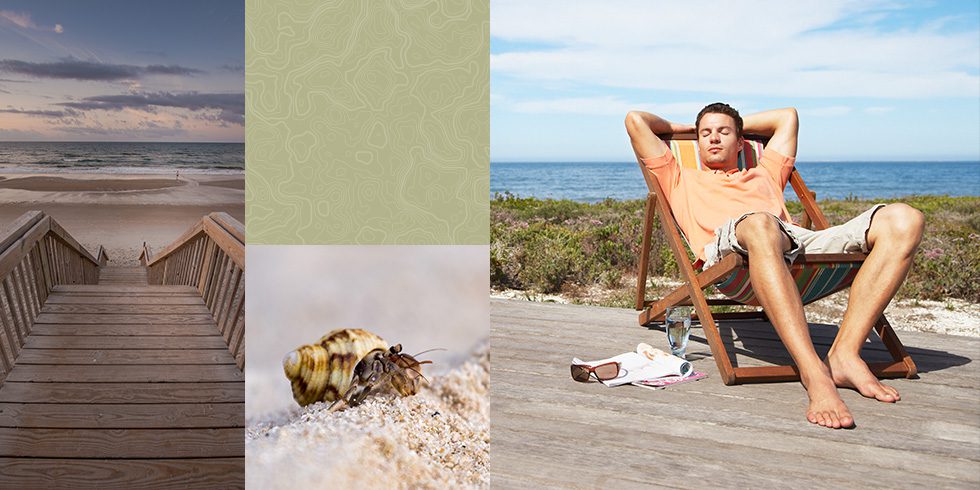 A man sitting in an outdoor chair next to the ocean.